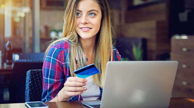 Woman entering a credit card number online.