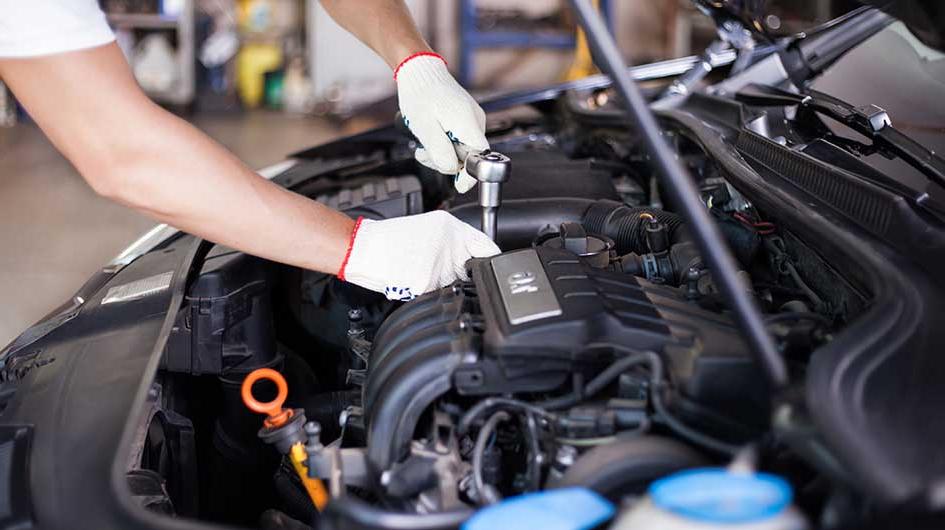 A mechanic provides engine maintenance.